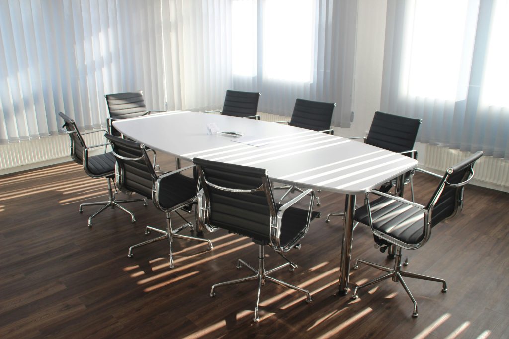 pexels-photo-416320-416320 Modern office meeting room with designer chairs, table, and large windows.
